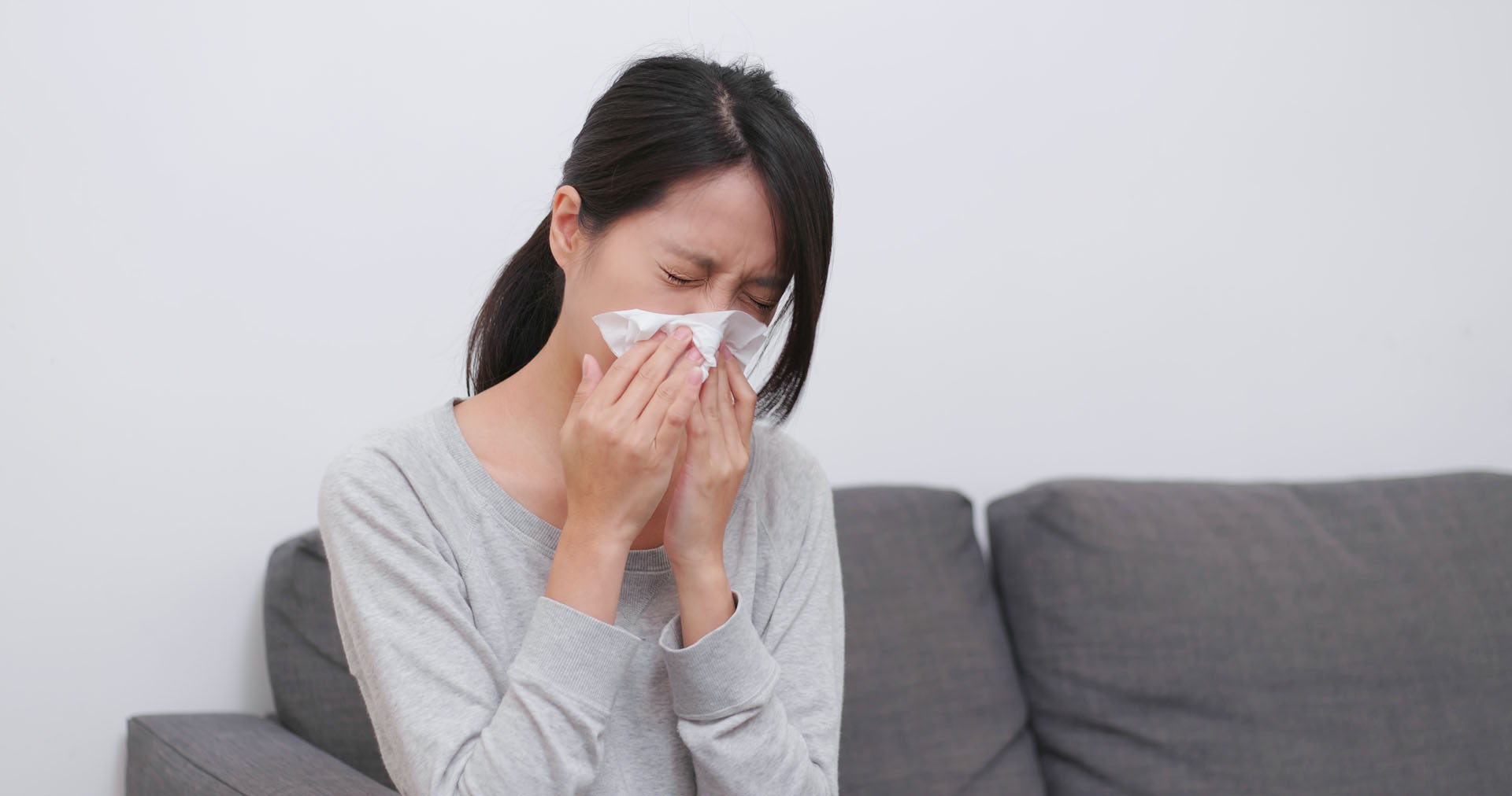 Woman sneezing and cough at home