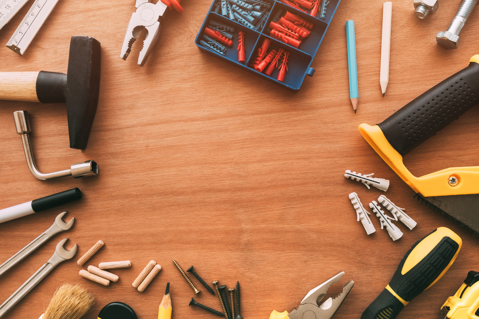 Handyman tools top view on workshop desk